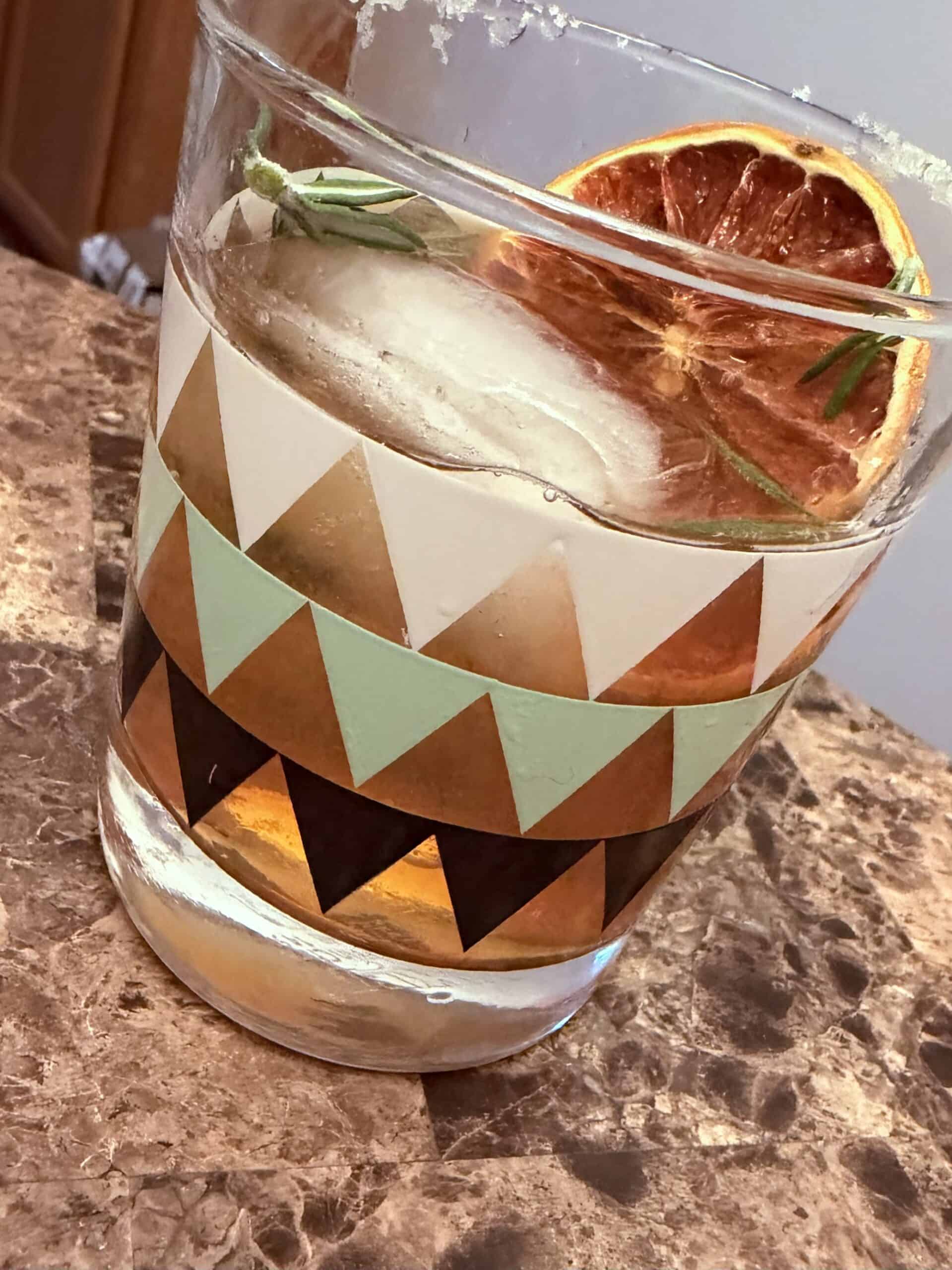 Second Hour Aperitivo Italian highball cocktail with salted rim, dried grapefruit wheel, and rosemary garnish